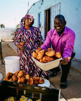 Annette and her husband serving food