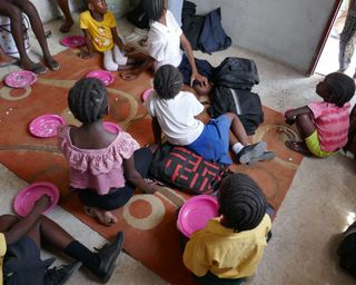 Children eating together in the soup kitchen