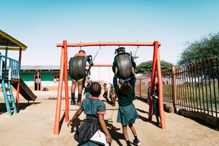 Children playing on a swing